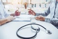 Doctors and patients sit and talk to the patient about medication. At the table near the window in the hospital Royalty Free Stock Photo