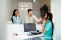 Doctors and patients speaking in the hospital waiting room Royalty Free Stock Photo