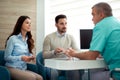 Doctors and patients speaking in the hospital waiting room Royalty Free Stock Photo