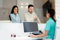 Doctors and patients speaking in the hospital waiting room Royalty Free Stock Photo