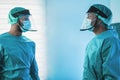 Doctors preparing to work inside hospital during coronavirus pandemic outbreak - Focus on right man face Royalty Free Stock Photo