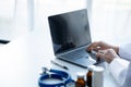 Doctors print treatment reports onto laptops in the hospital room, treating diseases from specialists and providing targeted