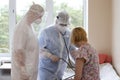 Doctors in protective suits are applying pressure to a patient who is sick with coronavirus