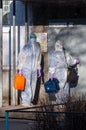 Doctors in protective suits at the door of an apartment building. coronavirus epidemic