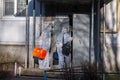 Doctors in protective suits at the door of an apartment building. coronavirus epidemic