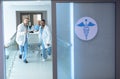 Doctors pushing emergency stretcher bed in corridor at hospital Royalty Free Stock Photo