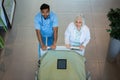 Doctors pushing emergency stretcher bed in corridor