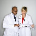 Doctors reading paperwork. Royalty Free Stock Photo