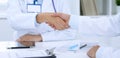 Doctors shaking hands to each other finishing up medical meeting Royalty Free Stock Photo