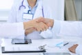 Doctors shaking hands to each other finishing up medical meeting Royalty Free Stock Photo