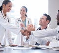 Doctors, staff or meeting with handshake, applause or congratulations with healthcare innovation, wellness or Royalty Free Stock Photo