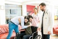 Doctors Standing By Man Greeting Woman After Leaving From Hospital Royalty Free Stock Photo