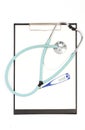 Doctors stethoscope, digital thermometer and blank clipboard on white background