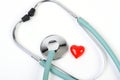 Doctors stethoscope and one small red heart on white background Royalty Free Stock Photo