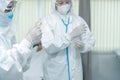 Doctors Surgeon in scrubs putting on surgical gloves. Doctors put on protective glove and mask and suit before proceed patient Royalty Free Stock Photo