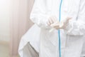 Doctors Surgeon in scrubs putting on surgical gloves. Doctors put on protective glove and mask and suit before proceed patient Royalty Free Stock Photo