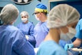 Doctors surgeons, anesthesiologist perform operation in sterile operating room