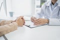 Doctors talk to patients about medications and ways to treat their symptoms. The doctor is taking notes on paper