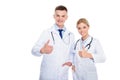 male and female doctors in white coats with stethoscopes and thumbs up