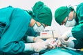 Doctors are wearing protective gloves, examining and treating patients in operating room equipped with modern medical equipment Royalty Free Stock Photo