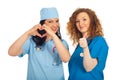 Doctors women with heart shape and thumbs