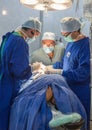 Doctors work on abdomen during surgery