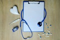 Doctors Work Desk In Hospital With Notepad, medical stethoscope, model heart, many colored pills, capsules, concept of maintaining