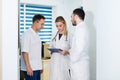 Doctors working in hospital and discussing over medical reports. Medical staff analyzing and working at clinic Royalty Free Stock Photo