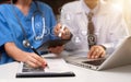 Doctors working together  with mobile phone and stethoscope and digital tablet laptop. Royalty Free Stock Photo