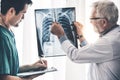 Doctors working with x ray film of patient chest. Royalty Free Stock Photo