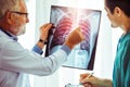 Doctors working with x ray film of patient chest. Royalty Free Stock Photo