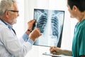 Doctors working with x ray film of patient chest. Royalty Free Stock Photo