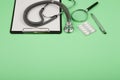 doctors workplace - medical tablet, stethoscope, pills and magnifying glass Royalty Free Stock Photo