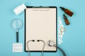 doctors workplace - medical tablet, stethoscope, pills and magnifying glass Royalty Free Stock Photo