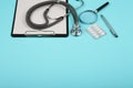 doctors workplace - medical tablet, stethoscope, pills and magnifying glass Royalty Free Stock Photo