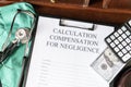 Document for calculating negligence compensation, with a stethoscope, money, and calculator on a medical uniform Royalty Free Stock Photo