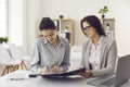 Two business woman signing contract agreement during meeting in office Royalty Free Stock Photo