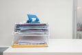 Document in documents tray with paper punch on the white table at the office area Royalty Free Stock Photo