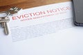 Document on eviction from housing for non-payment lies on table with keys Royalty Free Stock Photo