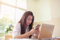 Document office Busy Business Concept: Behind Asian Businesswoman use smartphone for seaching information with documents paper for Royalty Free Stock Photo