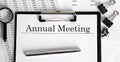 Document with text ANNUAL MEETING with chart, pen and magnifier, business Royalty Free Stock Photo