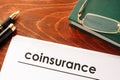 Document with title coinsurance on a table. Royalty Free Stock Photo