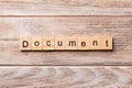 Document word written on wood block. Document text on wooden table for your desing, concept Royalty Free Stock Photo