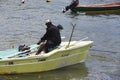 Documentary editorial image. Fisherman on small wood boat Royalty Free Stock Photo