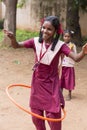 Documentary editorial image. Young child plays With Hula Hoop In Summer Field, in school