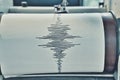 A Sismograph Recording Device with Seismic Waves Traced on Paper Royalty Free Stock Photo