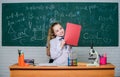 Documenting the result of experiments. Little scientist work with microscope. Little girls in school lab. Formal school