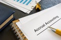 Documents about accrual accounting near notepad and pen.