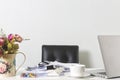 Documents, laptop, and coffee cup on office desk table on white screen