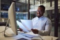 Documents, night and computer with a businessman working at his desk late in the office. Paperwork, finance and tax with Royalty Free Stock Photo